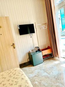 TV a/nebo společenská místnost v ubytování Xing City Hotel Dalat