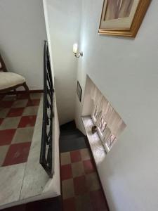 a staircase in a room with a checkered floor at Amaranta in Palermo