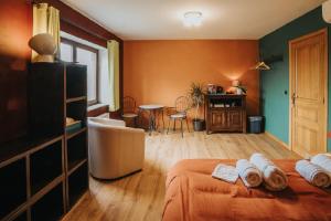 a room with two beds and a table in it at Le refuge de Kila in Waimes