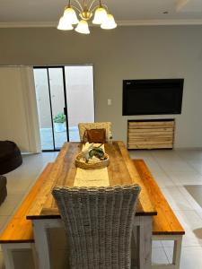 a dining room table with a plate of food on it at SOMS Langstrand Self Catering in Langstrand