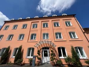 a large brick building with an arched doorway at Hotel Am Mühlenteich in Schwelm