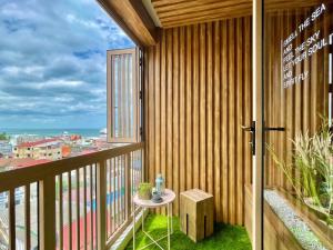a balcony with a table and a view of the city at Hub Hua Hin 57 in Hua Hin