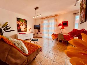 a living room with a couch and a table at Rivage hyper centre et plage a pied in Le Barcarès