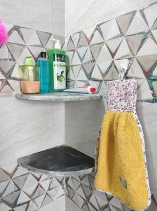 a yellow dress on a shelf in a bathroom at 2BHK AC Service Apartment 101 Manjari in Pune