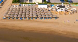 an aerial view of a beach with a stage and chairs at Hotel Regent in Pescara