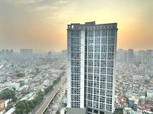 een hoog gebouw met een stad op de achtergrond bij BEU Home Vincom Royal City in Hanoi