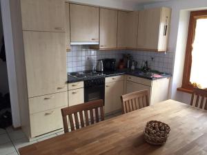 a kitchen with a wooden table and a kitchen with a bowl on the table at Appartement Casa Rancurina in Olivone