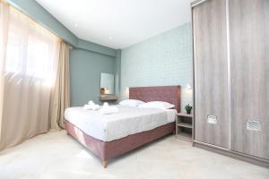 a bedroom with a large bed with white sheets at Corfu Studios & Apartments in Benitses +17 photos