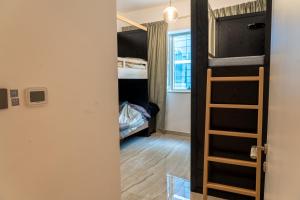 a small room with a bunk bed and a ladder at Joyful Journeys in Dubai