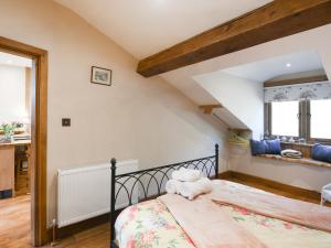 a bedroom with a bed in a room at The Red House - Uk39234 in Shelve