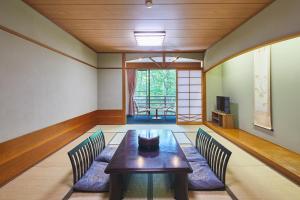 a dining room with a table and two chairs at Shiki Resort Belufore Nasu in Nasu