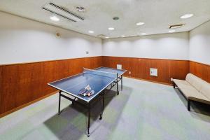 a ping pong table in a room with a couch at Shiki Resort Belufore Nasu in Nasu