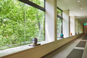 a hallway with a window with vases on display at Shiki Resort Belufore Nasu in Nasu +2 photos