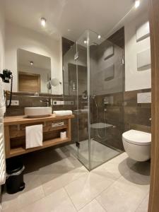 a bathroom with a glass shower and a toilet at Pöltnerhof in Weilheim in Oberbayern