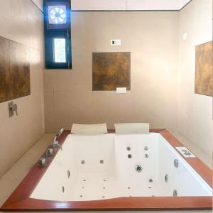 a large white bath tub in a bathroom at pool loft in Jaipur