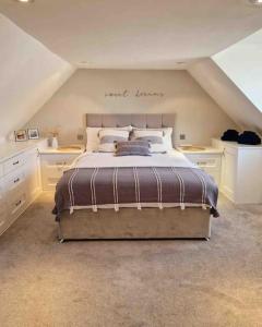 a bedroom with a large bed in an attic at Cullen Seaside Cottage in Cullen