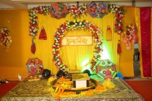 a room with a table with an arch with flowers at The Bliss in Kolkata