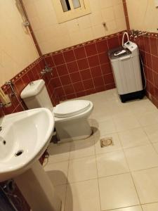 a bathroom with a toilet and a sink at شقق اطلالة أبحر للشقق المخدومة in Jeddah