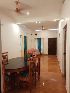 a dining room with a table and chairs at Enna homestay in Varkala
