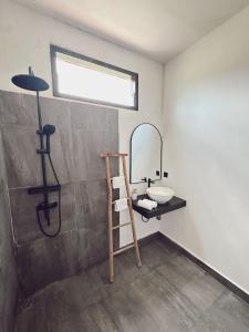 a bathroom with a sink and a mirror at The Confidential Mandalika in Kuta Lombok