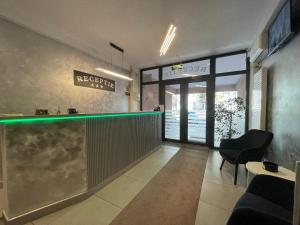 a lobby with a bar with a sign on the wall at Hotel Rivoli in Bucharest