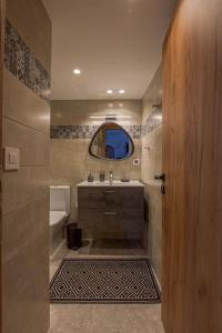 a bathroom with a sink and a mirror at ElizabethHouse in Mármara