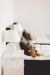 two teddy bears sitting on a bed with pillows at Frost Boutique Hotel in Pärnu +49 photos