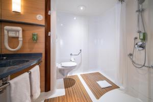 a bathroom with a toilet and a sink at B&B HOTEL Calais Terminal Cité Europe 4 étoiles in Coquelles