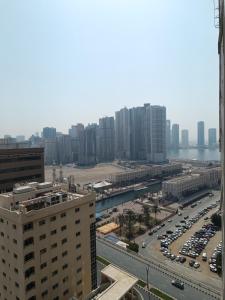 a city with cars parked in a parking lot at Home stay - FEMALE GUEST ONLY -ممنوع دخول الرجال in Sharjah