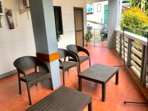 a group of chairs and a table on a balcony at Badladz Staycation Condos in Puerto Galera