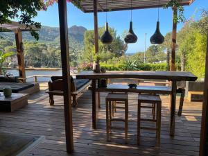 a wooden deck with a wooden table and chairs at Villa Java in Cassis