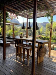 a wooden deck with a table and benches and pendant lights at Villa Java in Cassis