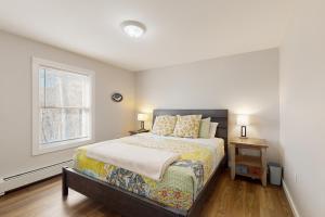a bedroom with a bed and a window at Peakes Peace - B in Dedham