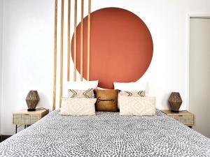 a bedroom with a bed with a large orange headboard at *NEW* ALBA 6 pax Appart 8min Disney in Serris