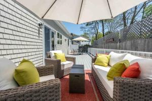 a patio with wicker chairs and an umbrella at Hidden Gem Hideaway in Centerville