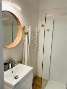 a bathroom with a white sink and a mirror at Apartament Foka - Rowy in Rowy