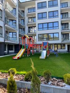 a playground in front of a apartment building at Apartament Foka - Rowy in Rowy