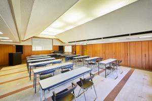 a classroom with rows of tables and chairs at Shiki Resort Villa Hakone 80 in Hakone