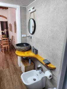 a bathroom with a sink and a mirror at ANCORA GIGLIO home in Giglio Porto