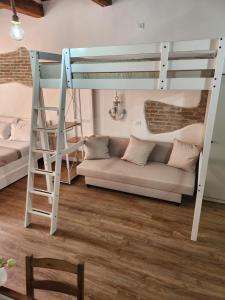 a living room with a bunk bed and a couch at ANCORA GIGLIO home in Giglio Porto +9 photos
