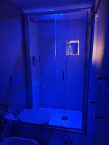 a bathroom with a shower with a glass door at ANCORA GIGLIO home in Giglio Porto