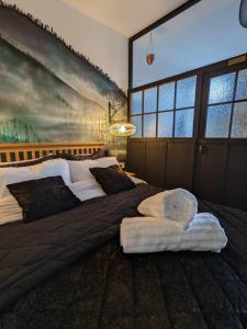 a bedroom with two beds and a large painting on the wall at Cwmcarn Hotel & Bunkhouse in Cwmcarn