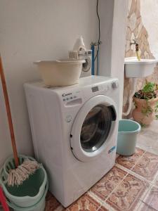 a washing machine with a bowl on top of it at Da Zia Dorina in Siniscola