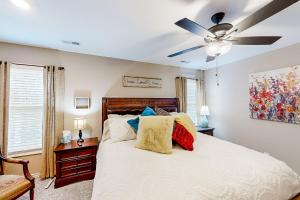 a bedroom with a bed with a ceiling fan at Old Woodland Station in Clarksville
