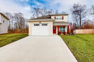 a driveway leading to a house with a white garage at Old Woodland Station in Clarksville