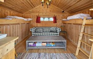 a cabin with a couch and two bunk beds at Cozy Home In Gol With Sauna in Golsfjellet
