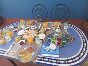 - une table avec des assiettes de nourriture et de boissons dans l'établissement Riad Dar Doura, à Rabat