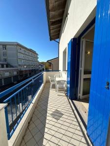 a balcony with tables and chairs on a building at RESIDENCE STEFANIA ATTICI SU 2 LIVELLI - AGENZIA COCAL in Caorle