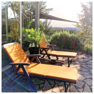 a group of chairs sitting on a patio at Le Gîte des Cimes in Tulle