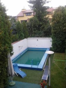 a small swimming pool with a chair and a table at Duże pokoje w nowoczesnym stylu in Kielce